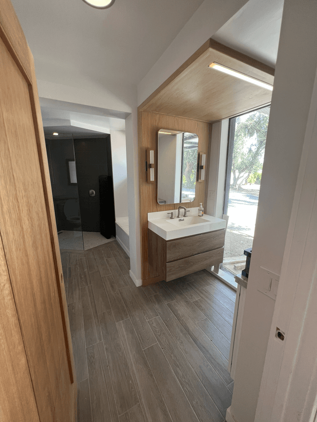 Modern bathroom remodel with floating wood vanity in Woodland Hills